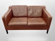 A late 20th century Danish brown leather three piece lounge suite