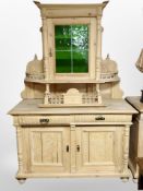 An early 20th century Scandinavian pine sideboard with leaded glass door cabinet above,