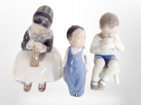 Three Royal Copenhagen figures of children.