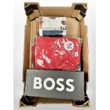 A box of new retail stock items - leather belt, Boss Crew neck shirt, two red polo tops,