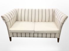 A 20th century two seater settee in striped upholstery,