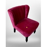 A contemporary wing back chair in pink upholstery