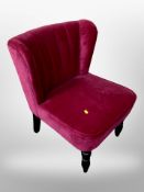 A contemporary wing back chair in pink upholstery