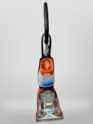 A Vax upright carpet cleaner.