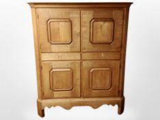 An early 20th century Scandinavian oak hall cupboard fitted with cupboards and drawers,