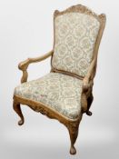 A 19th century Danish heavily carved beech armchair in tapestry upholstery