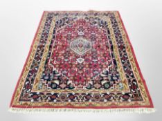 An Iranian woolen rug on red ground,