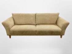 A contemporary Scandinavian three seater settee in suede upholstery,