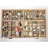 A printer's type tray containing a quantity of figurines and trinkets,