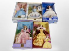 A group of five boxed Barbie dolls, including Rapunzel, Belle, Peter Rabbit and two others.