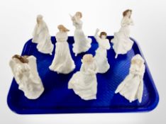 Eight Royal Doulton porcelain figurines including Christmas angel, loving you, Christmas carols,