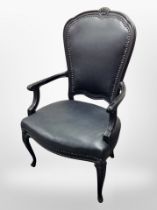 A continental ebonised salon armchair in studded black leather