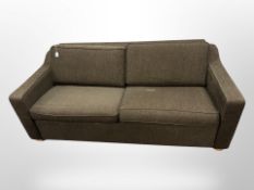 A contemporary three-seater settee in brown upholstery,