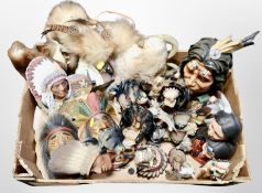 A box of resin Native American masks and busts.