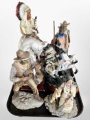 A group of diecast resin Native American and cowboy figures.