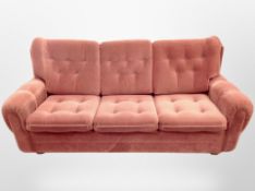 A 20th century Danish three seater settee in buttoned fabric,