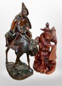 An oriental carved wooden figure of a man riding a camel,