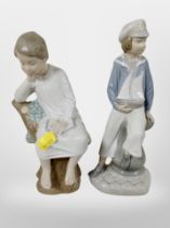 A Lladro figure of a boy dressed as a sailor, and a further boy sitting on a tree stump.