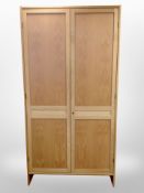 A contemporary Danish blond oak double door wardrobe,