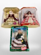 Three boxed Barbie Happy Holidays dolls.