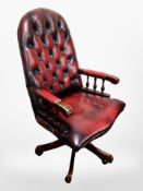 A Chesterfield oxblood buttoned leather swivel office chair