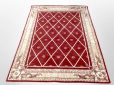A machine made rug on red ground,