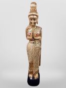 A Thai gilt wood figure with 'jewelled' decoration, on ebonised plinth,