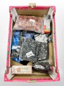 A box of new retail stock items - Swimming goggles, shin pads,