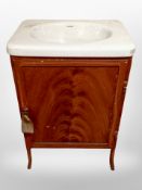 A painted metal cabinet with inset porcelain sink,