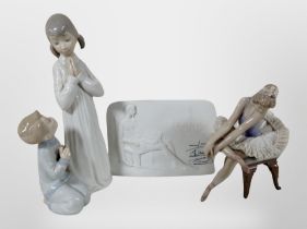 A Lladro figure of a seated ballerina, a further figure of a girl and boy kneeling,
