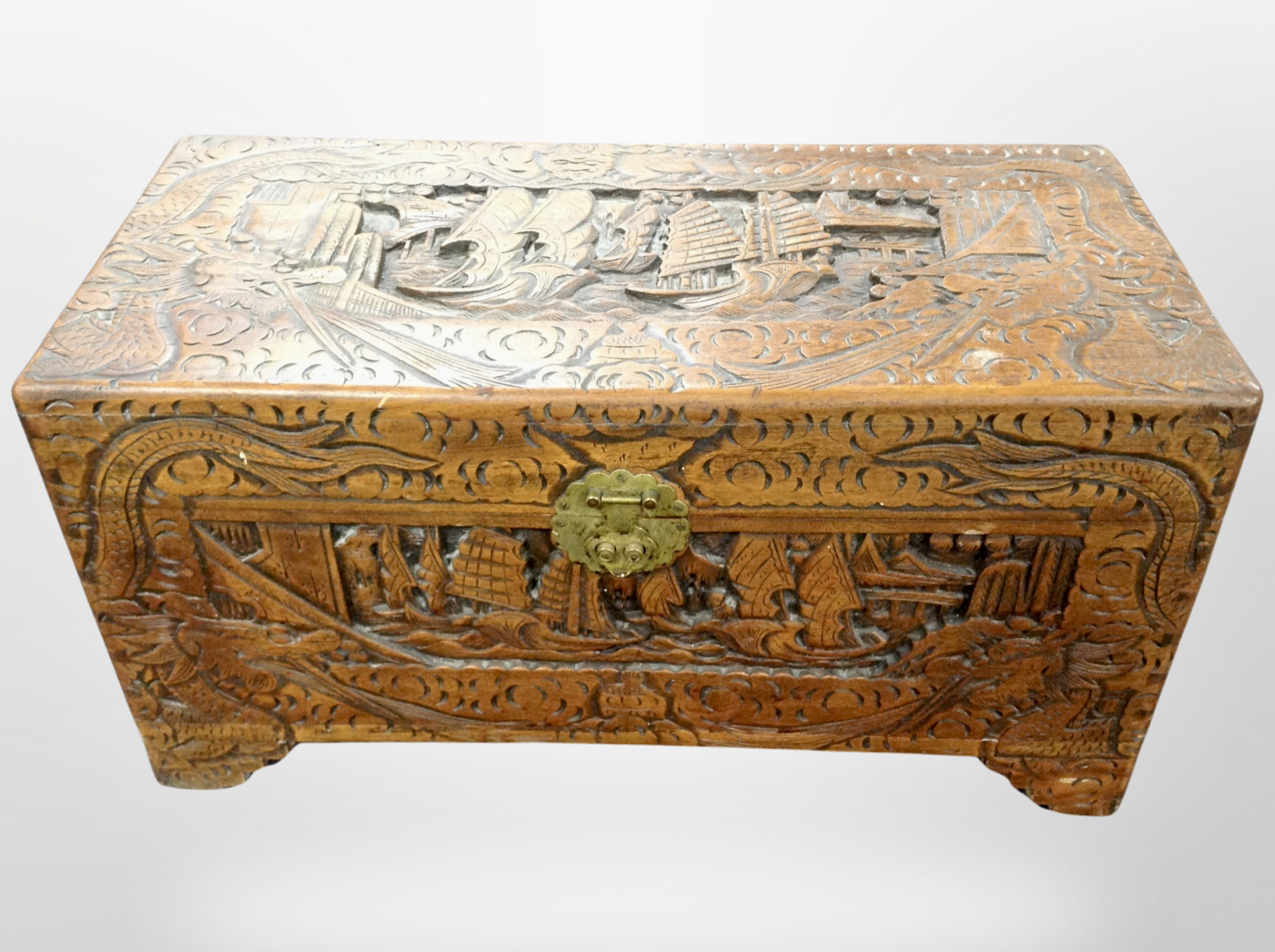 A Chinese heavily carved camphor wood blanket chest,
