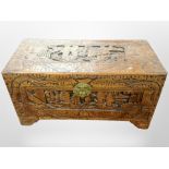 A Chinese heavily carved camphor wood blanket chest,