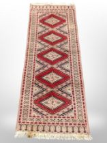 An Afghan runner of geometric design,