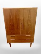 A 1970's Danish teak double door cabinet fitted with drawers,