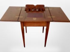 An Edwardian walnut envelope writing table, with rise and fall correspondence rack,