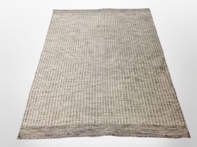 A 20th century machine made woolen rug,