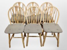 A set of six oak wheel backed chairs with fabric cushions