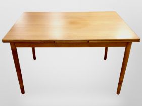 A 20th century Danish teak pull out dining table,
