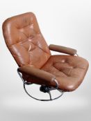 A 20th century Scandinavian tan buttoned leather armchair on chrome base