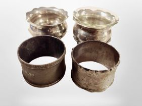 Two silver salts and two napkin rings.