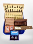 A chess set in box, two sets of dominoes, boxed playing cards,