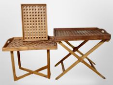 Two teak lattice trays on stands and a further tray