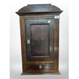 A 19th century continental stained oak wall cabinet fitted a drawer, width 40cm.