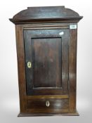 A 19th century continental stained oak wall cabinet fitted a drawer, width 40cm.