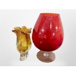 An over-sized ruby glass goblet, height 39cm, together with an art glass vase.