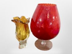 An over-sized ruby glass goblet, height 39cm, together with an art glass vase.