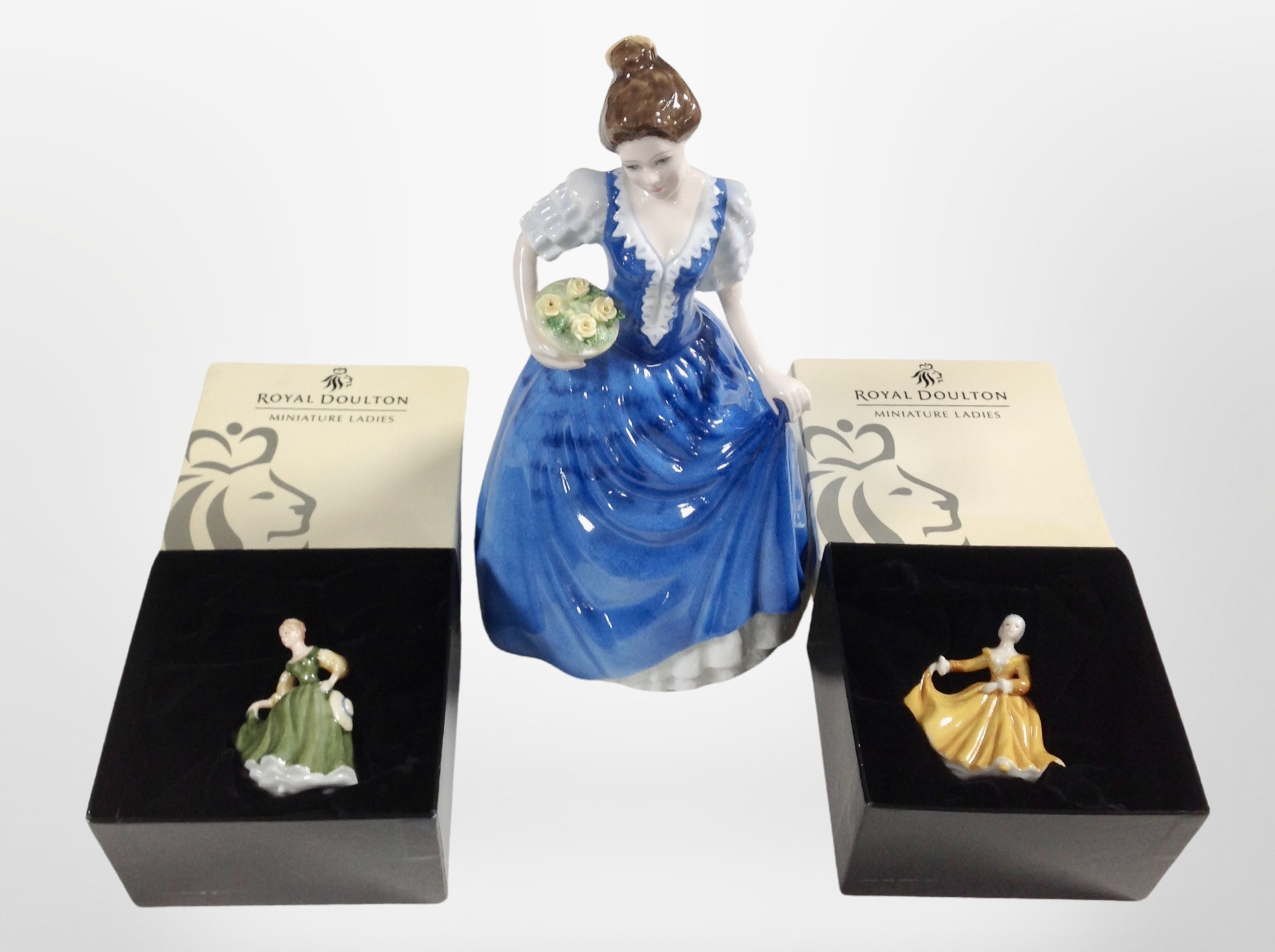 A Royal Doulton figure, Helen HN3601, and two further boxed Royal Doulton miniature ladies.