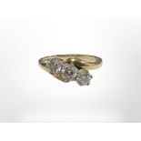 An 18ct yellow gold three stone diamond ring, approximately 0.5ct, size R.