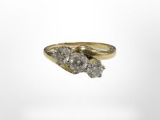 An 18ct yellow gold three stone diamond ring, approximately 0.5ct, size R.