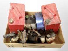 A box of vintage oil cans, blow torches.